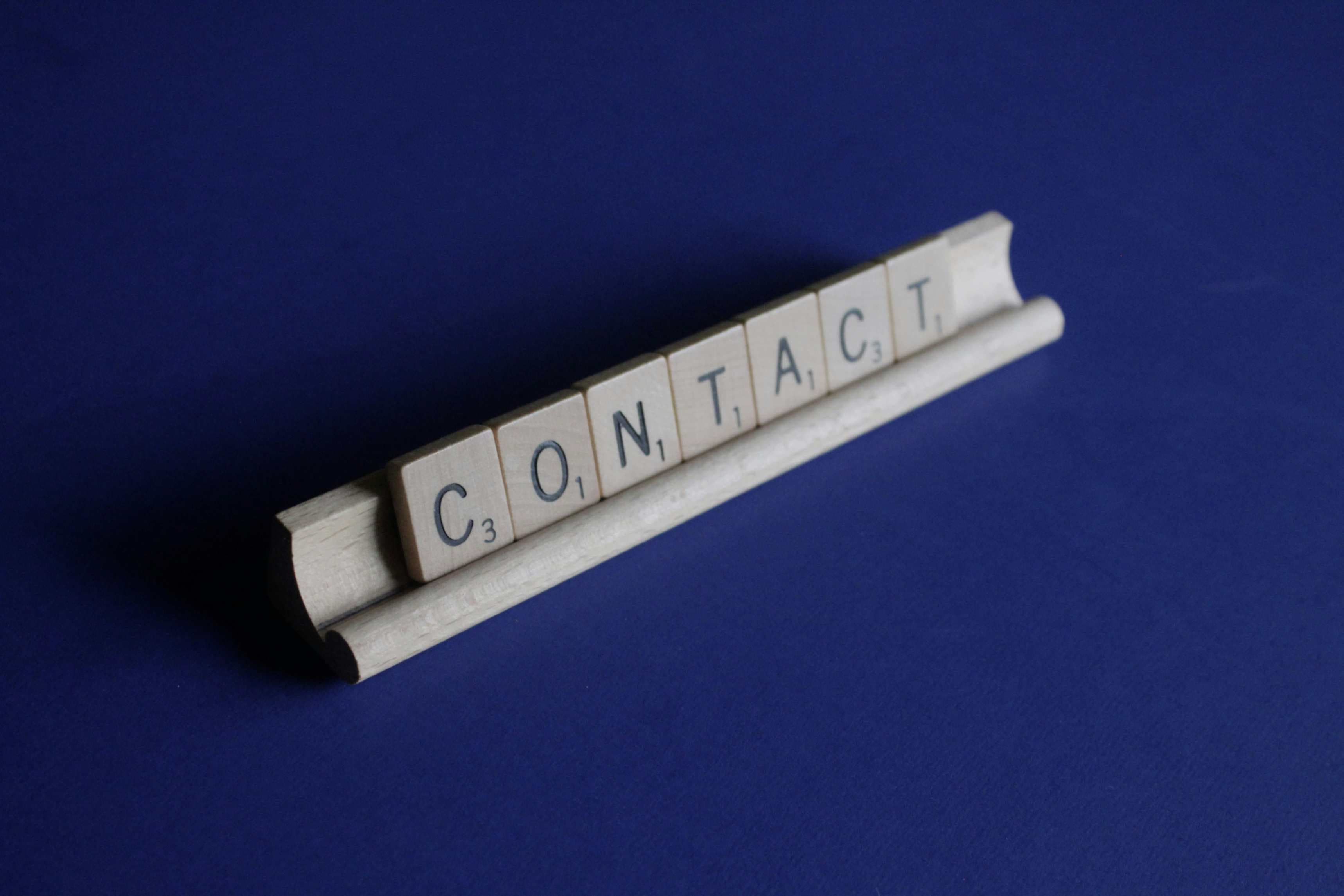 Scrabble tiles spelling the word 'CONTACT'